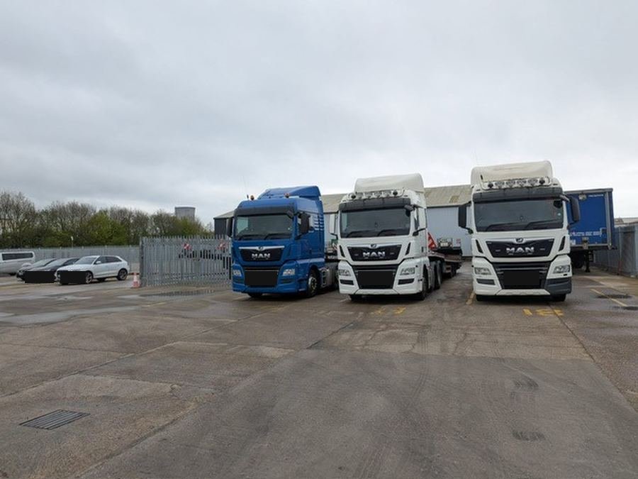 Three CaraNation trucks in the yard